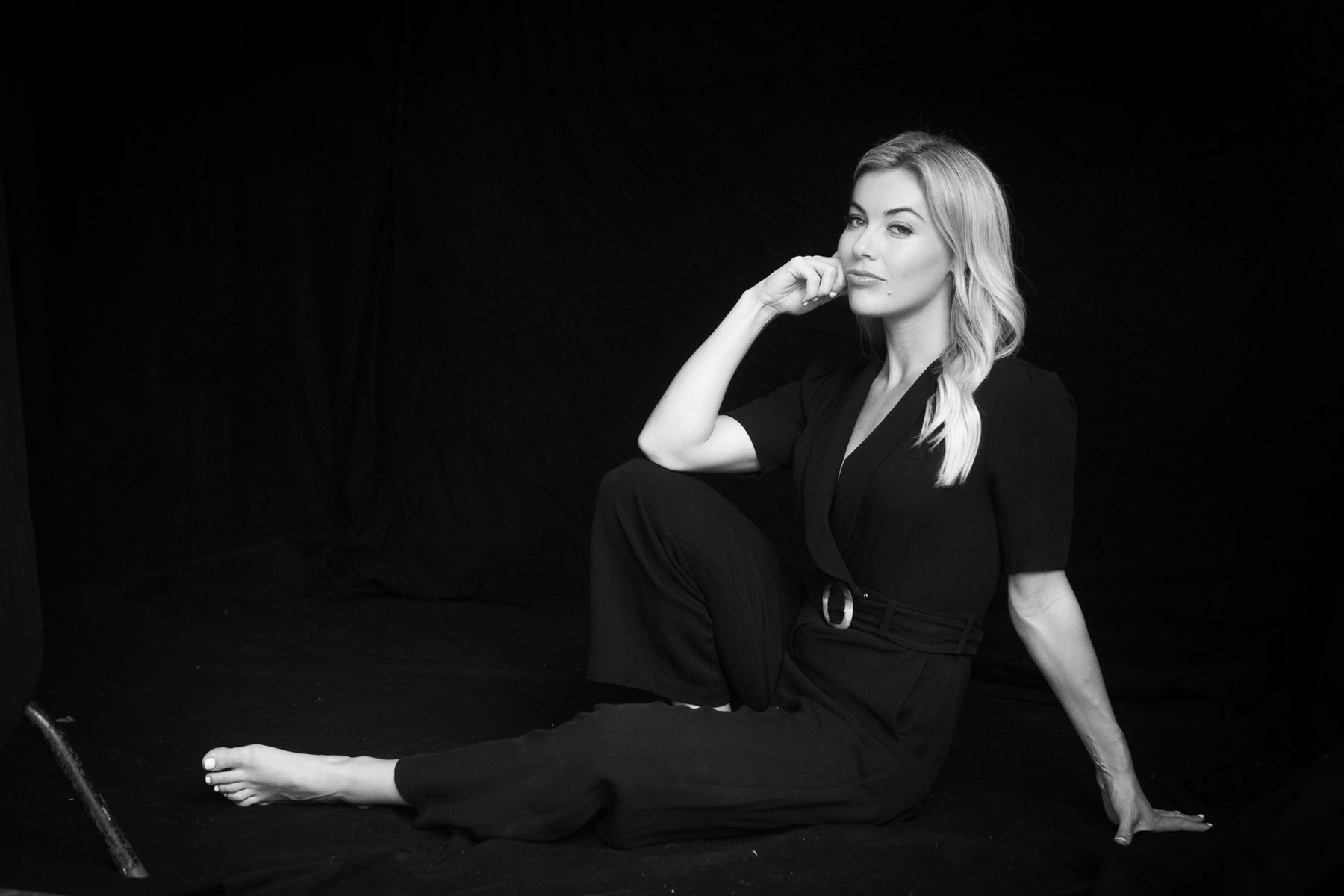 Black and white portrait of Gabriella Power seated on the studio floor